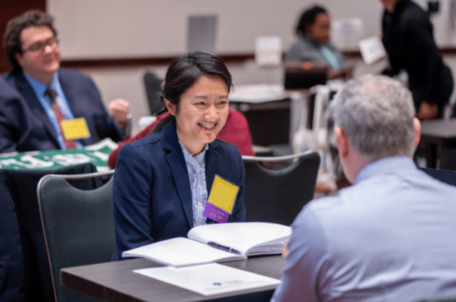 girl smiling across the table from her interviewer