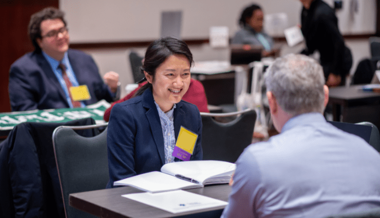 girl smiling across the table from her interviewer