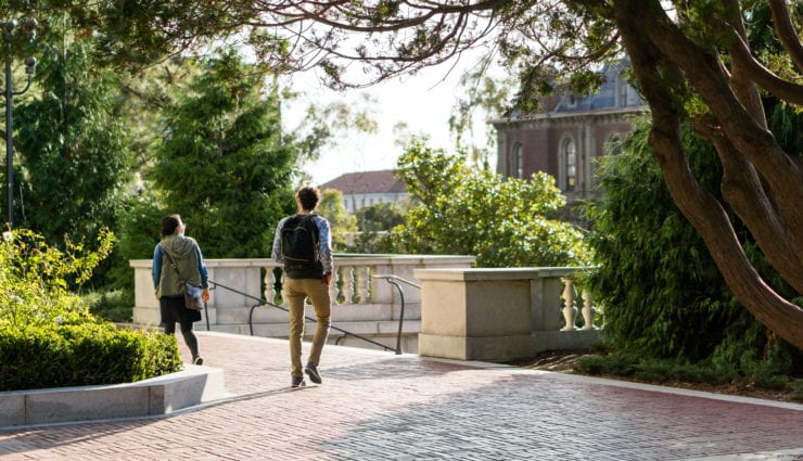 male and female students walking on campus