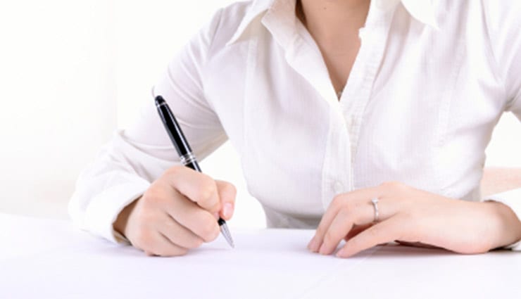 business woman's hands writing with pen