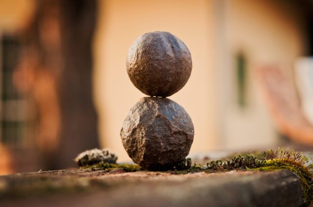 one round rock balancing on top of another rock