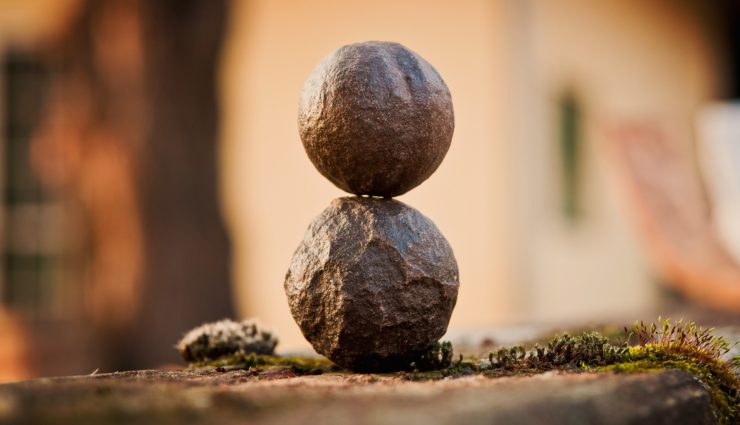 one round rock balancing on top of another rock