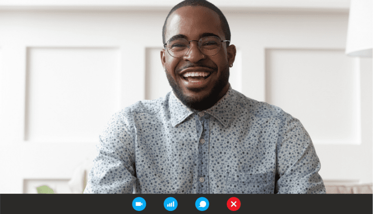 A Black man is smiling from the browser window of a virtual interview