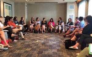Attendees sitting in a circle during a breakout session