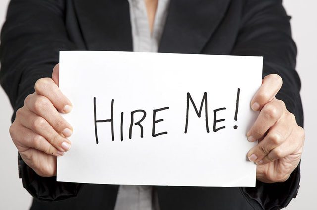 Businesswoman holding a sign with message 