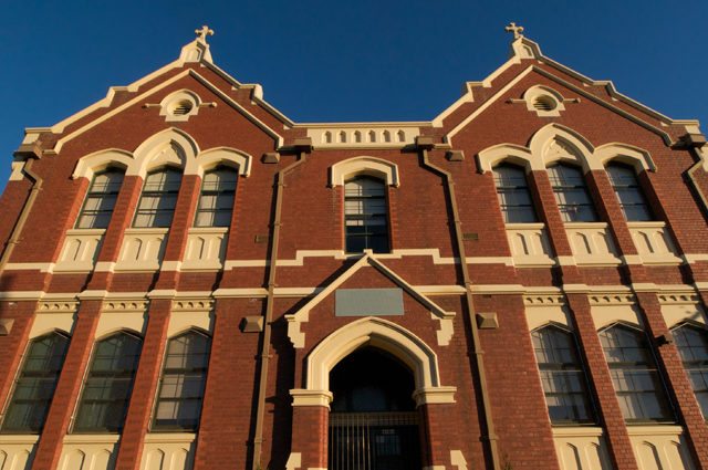 Entrance to red brick Catholic school