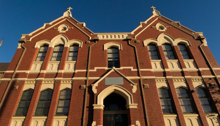 Entrance to red brick Catholic school