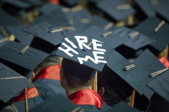 Graduation cap with hire me written on it in white tape