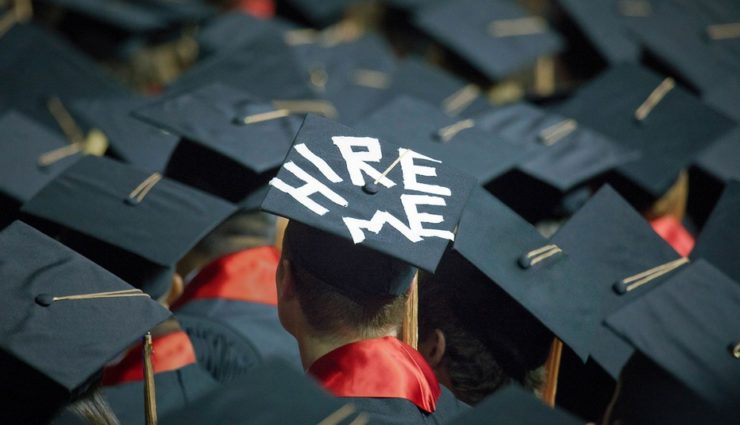 Graduation cap with hire me written on it in white tape