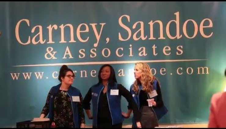 three csa employees with the logo behind