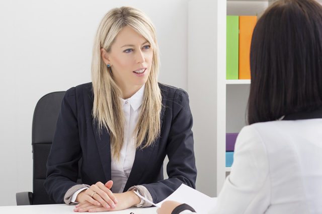 Two business women discuss in an office