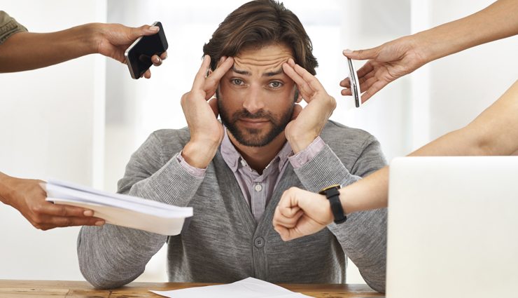 man is under stress as he is handed lots to do