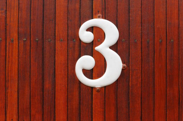 The number 3 against a wood background