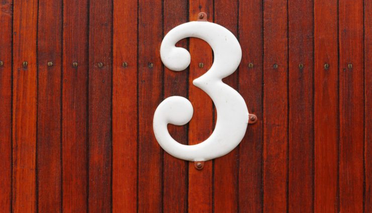 The number 3 against a wood background