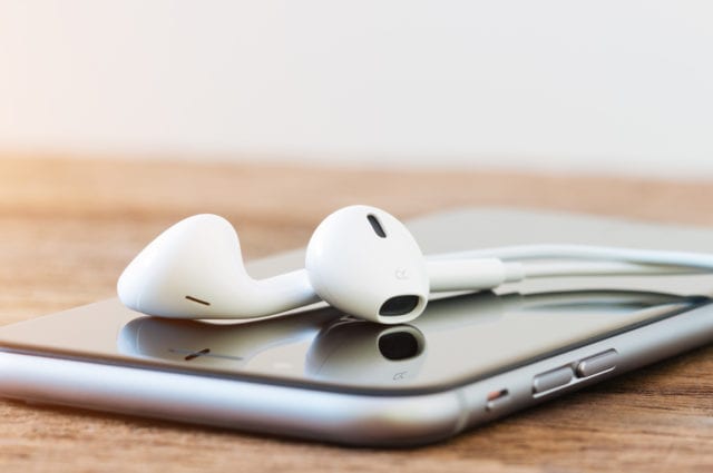 closeup phone and headphone device on table