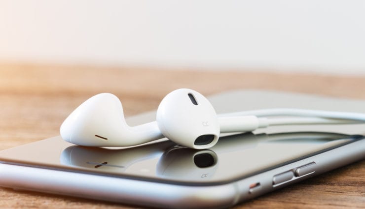 closeup phone and headphone device on table