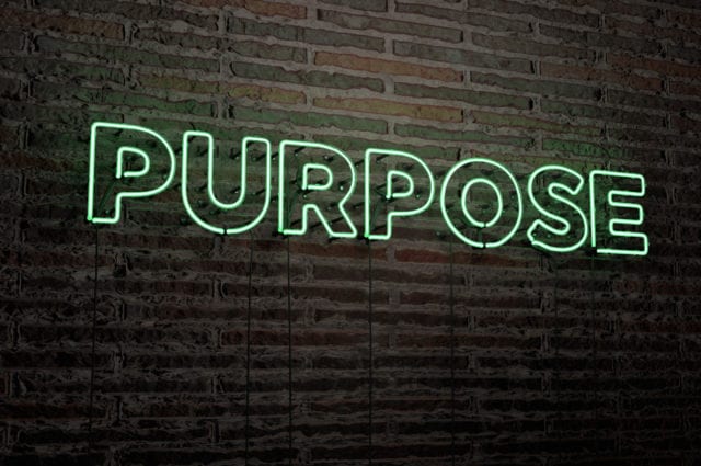The word purpose as a green neon sign