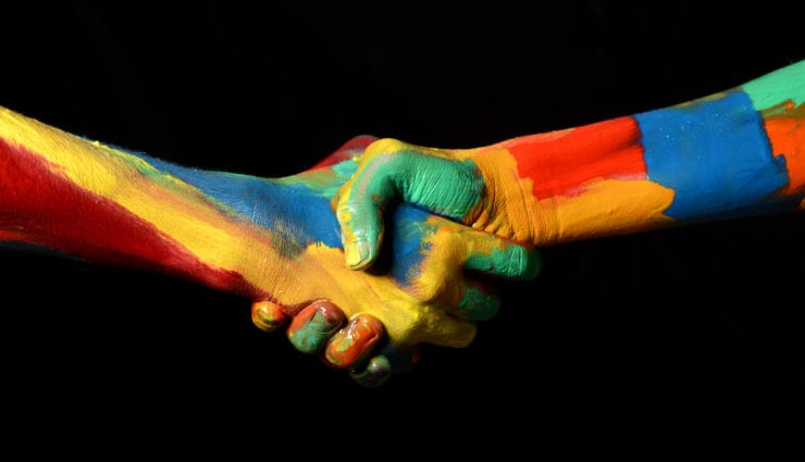 two colorfully painted hands shaking