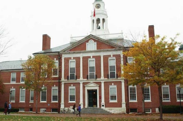 Red brick colonial style boarding school building with bell atop