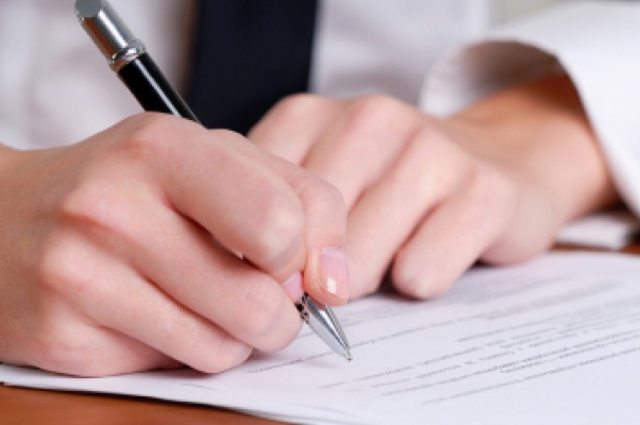 Zoomed in on woman's hand completing a form