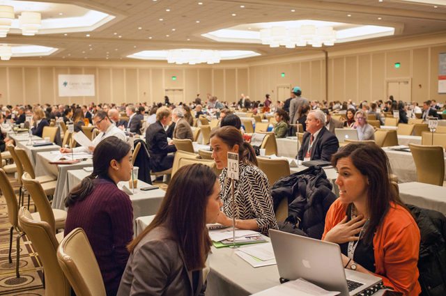 Conference ballroom filled with pairs of people conducting interviews