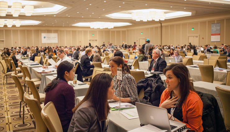 Conference ballroom filled with pairs of people conducting interviews