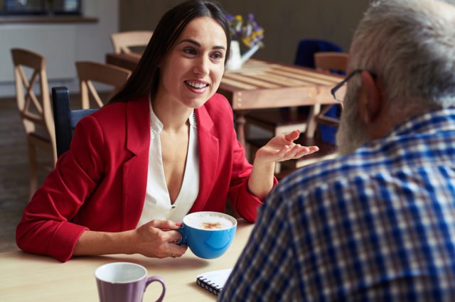 Women talking to interviewer over coffee