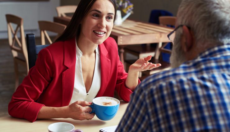 Women talking to interviewer over coffee