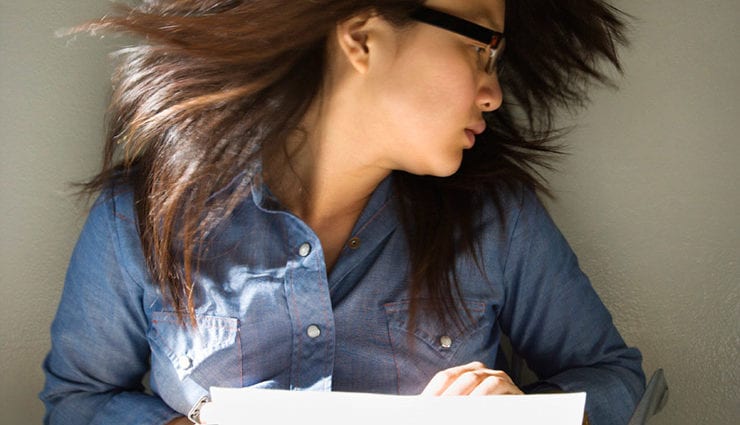 girl types on typewriter flipping hair