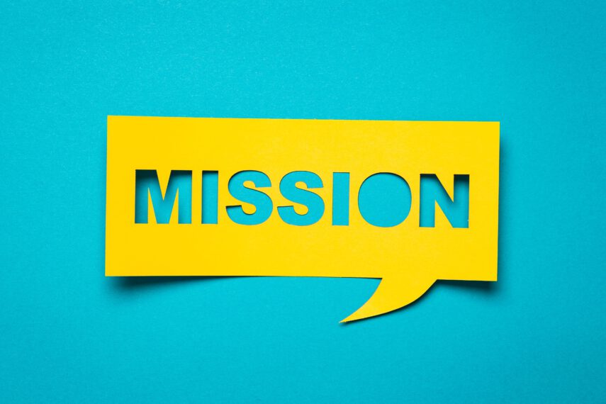 Bubble speech with cut out phrase "mission" in the paper.