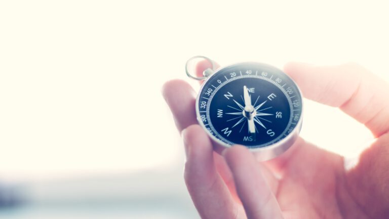 hand holding compass
