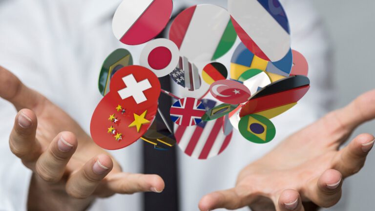 Flags of various countries floating above a person's open hands, symbolizing global communication and diversity.
