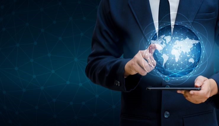 Businessman interacting with digital globe on tablet screen, representing global technology and communication.