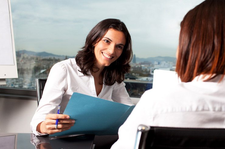 Woman interviews another woman in office