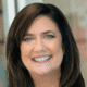 Smiling woman with dark hair in a professional setting.