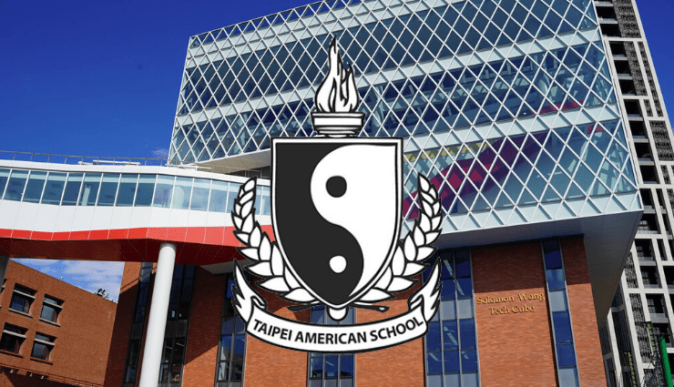 emblem with yin-yang symbol and torch over modern building facade with glass panels