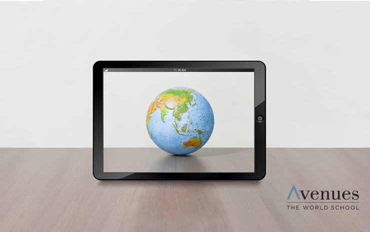 Tablet displaying a globe on a wooden table, blending digital and physical worlds.