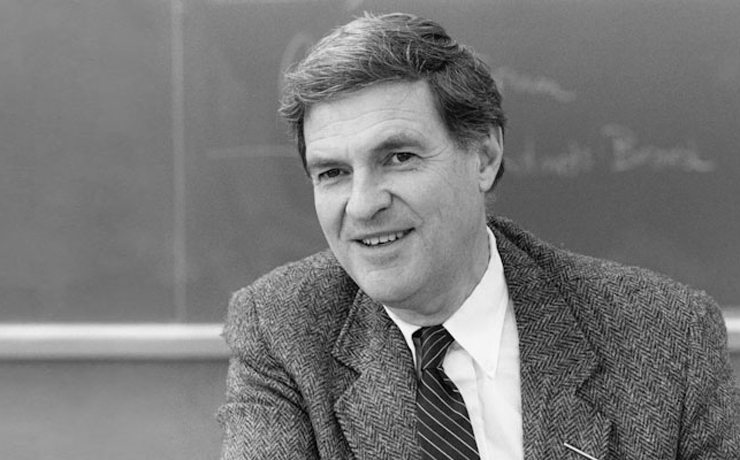 Ted Sizer headshot in front of a chalkboard