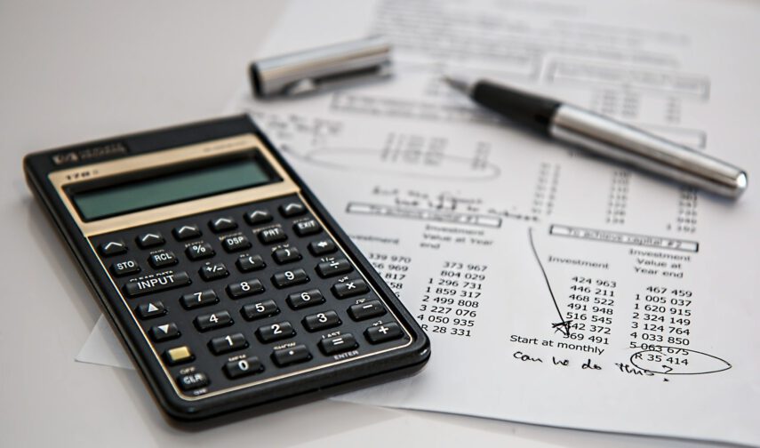 Calculator next to paper tax forms