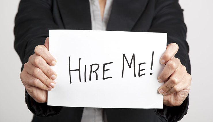 Businesswoman holding a sign with message "Hire me"