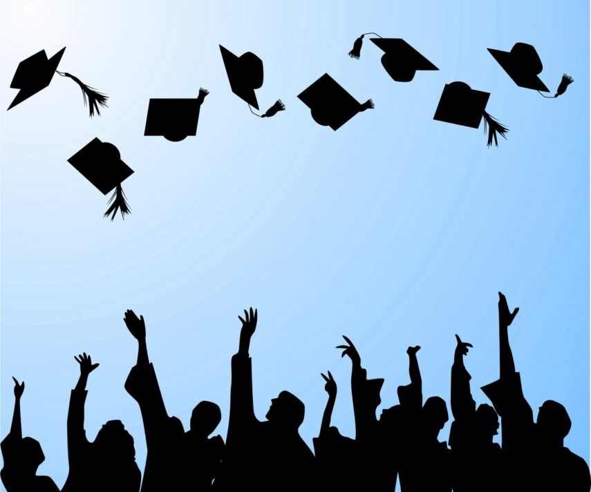 silhouttes of graduates throwing their caps