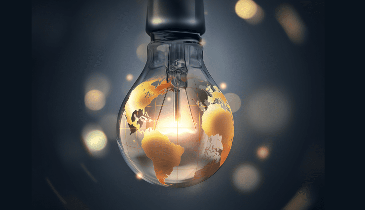 Light bulb with glowing world map, symbolizing global ideas or innovation against a dark, blurred background.