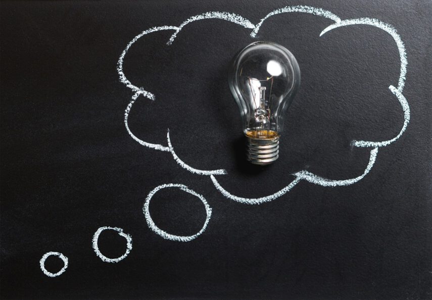 Light bulb against a chalkboard with a thought bubble drawn around it