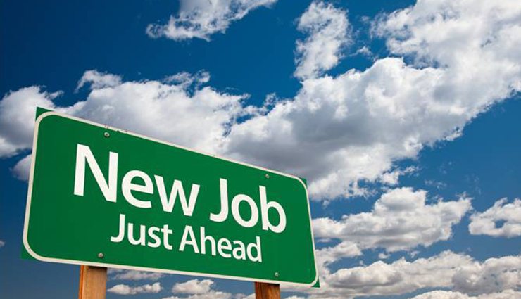 Road sign reading "new job just ahead" with blue skies behind