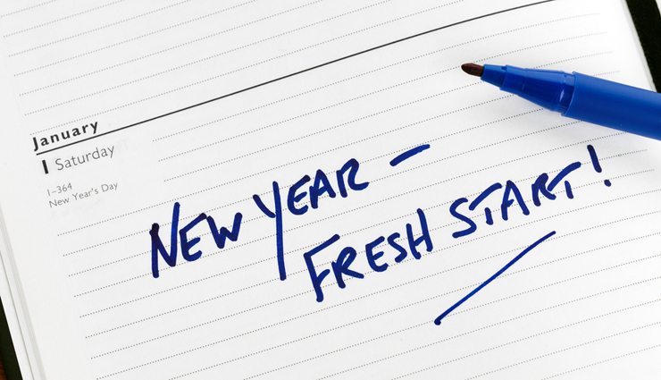 Calendar page with blue writing that reads "new year- fresh start!"