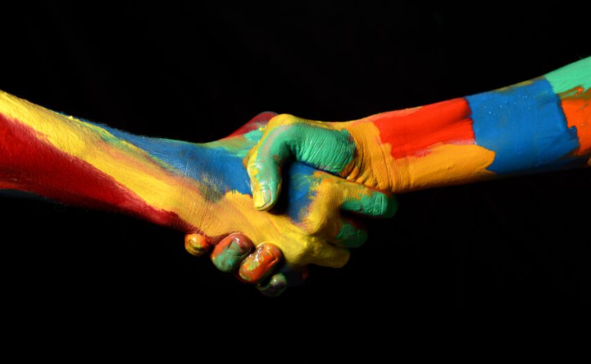 two colorfully painted hands shaking