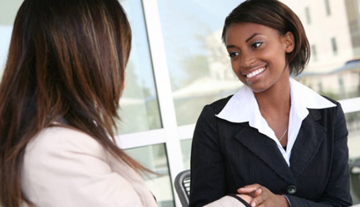 Two businesswomen shake hands