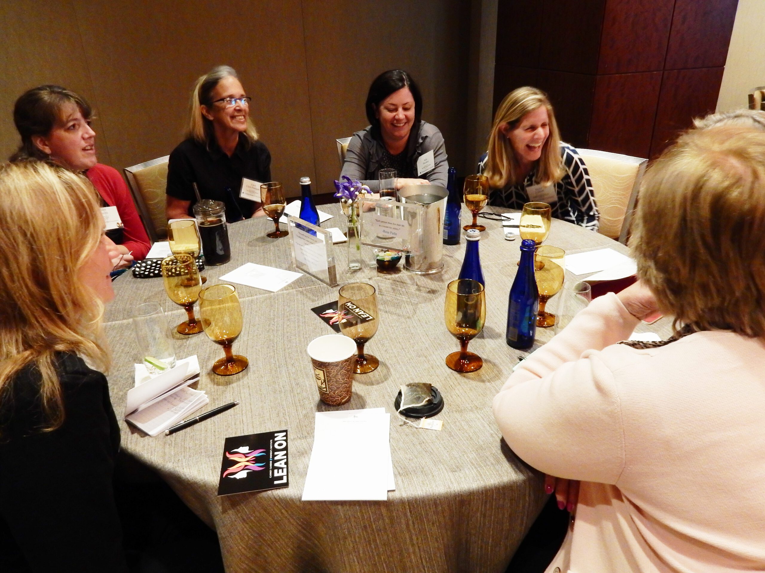 Attendees laughing around a table