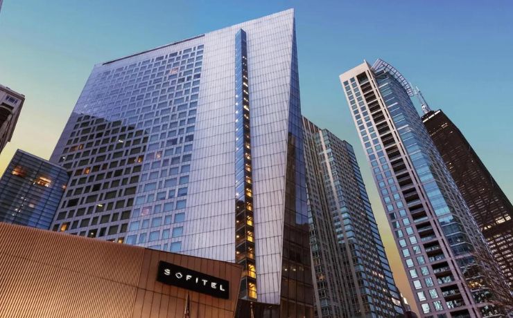 tall modern hotel building with glass facade in urban setting at dusk