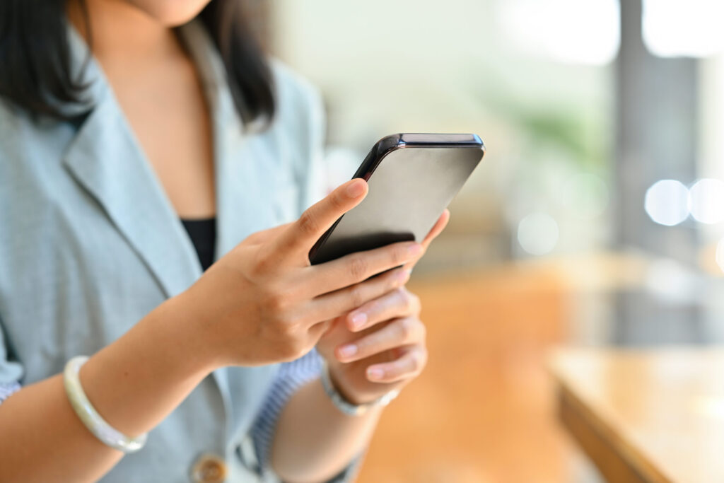 Close up woman in the office using a smartphone, for business and technology concept.